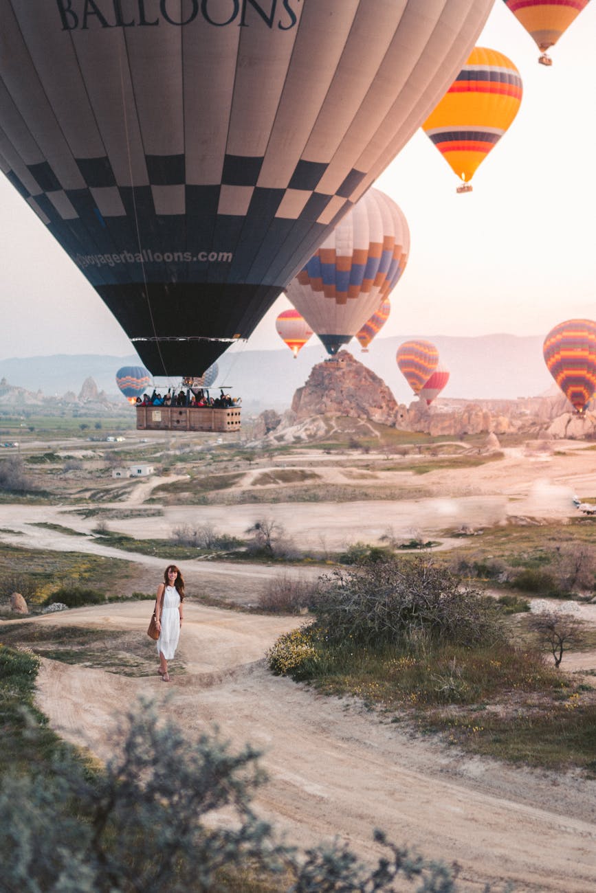 woman standing under hot air balloons