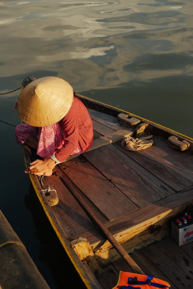 person sitting on brown wooden boat